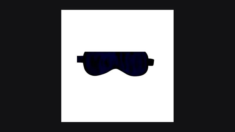 Navy 22-momme mulberry silk sleep mask centered on dark editorial backdrop